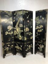 Four Panel Chinese folding screen on matt black ground with soapstone and gold gilt decoration