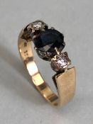 Large Sapphire and Diamond 9ct Gold ring the central faceted Sapphire flanked by illusion set