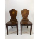 Pair of Edwardian shield back hall chairs, on tapering legs with inlay detailing (A/F)