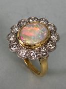 18ct Yellow Gold Opal & Diamond cluster ring the Oval cut Opal set in a tellow gold rope design