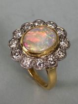 18ct Yellow Gold Opal & Diamond cluster ring the Oval cut Opal set in a tellow gold rope design