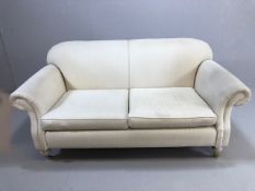 Modern two seater cream upholstered sofa