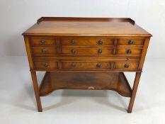 Mahogany occasional table with nine drawers and shelf under
