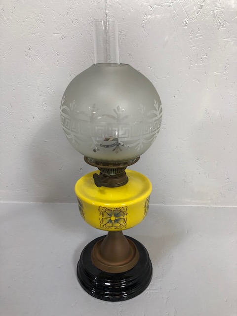 Antique 19th century brass oil lamp, modernist yellow reservoir with frosted glass shade on a