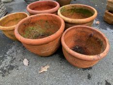 Five circular similar garden pots