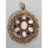 19th century Oval fretwork Victorian pendant set with rubies and opals in a snowflake design,