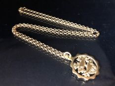 14ct Gold medallion depicting fish in a naturalistic setting (approx. 5g) on a 9ct Gold chain approx