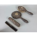 Silver hallmarked dressing table or vanity set comprising mirror, two brushes and a silver back comb