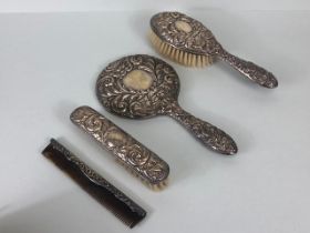 Silver hallmarked dressing table or vanity set comprising mirror, two brushes and a silver back comb