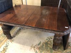 Victorian Oak Dining table on heavily carved tapering legs on casters with wind out mechanism to