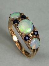 9ct Gold three stone Graduated Opal ring set the Opals separated by pairs of Blue Gemstones size