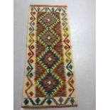 Oriental hand knotted wool rug with geometric designs approximately 145 x 61 cm