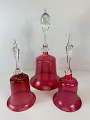 Decorative Glass, three Victorian cranberry glass bells of varying sizes approximately 41cm high,