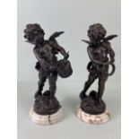 Bronze Figures, two 19th century style patinated bronze statues on marble bases of Putti playing