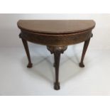 Antique Furniture, early 20th century halfmoon card table, folded top with carved border and baize