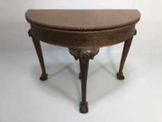 Antique Furniture, early 20th century halfmoon card table, folded top with carved border and baize