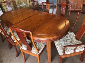 Modern Chinese hardwood extendable table and chairs (two carvers) with matching Alter style