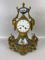 Antique clock, French 8 day mantel clock of gilt metal with inset porcelain plaques twin train