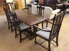 Four plank oak refectory-style table with central cross stretcher and pegged breadboard ends, on