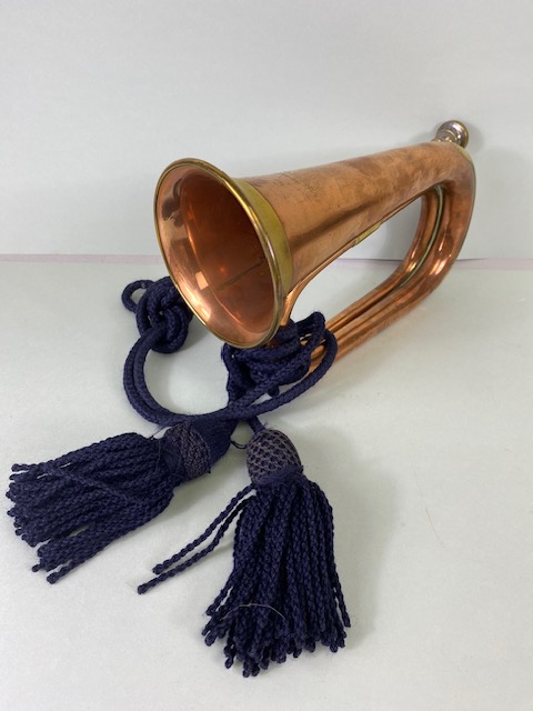 Musical instruments, vintage military brass bugle with blue tassel cords marked Dallas London.