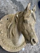 Concrete horses head on circular plinth, approx 55cm in diameter