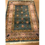 Modern Rug of oriental design, geometric patterns on a two colour back ground approximately 230 x