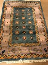 Modern Rug of oriental design, geometric patterns on a two colour back ground approximately 230 x