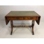 Reproduction regency style side table, leather insert top with drop down leaves supported at the