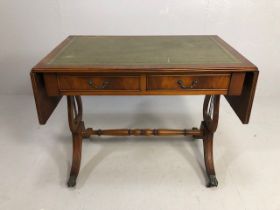 Reproduction regency style side table, leather insert top with drop down leaves supported at the
