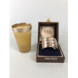 Hallmarked silver rimmed horn toast cup and a cased hallmarked silver napkin ring (46.5g)