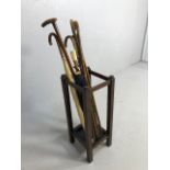 Collection of Vintage walking sticks and umbrellas in a square oak stand with drip tray