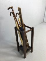 Collection of Vintage walking sticks and umbrellas in a square oak stand with drip tray