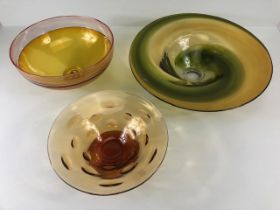 Art Studio glass, Three amber glass bowls all with ground bases one with a signature