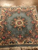 Chinese wool rug of sculpted style with typical designs of flowers and trellis against a blue grey