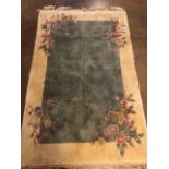 Chinese wool rug of sculpted style with typical designs of flowers against a blue grey back ground
