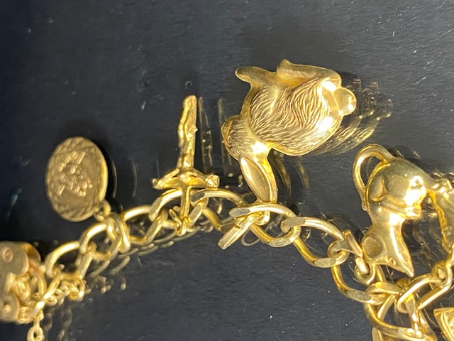 9Ct Gold charm bracelet with a collection of 9ct gold charms, to include, rabbit, Dolphins, Boot, - Image 3 of 9