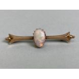 Unmarked antique gold bar brooch set with a pear shaped opal approximately 5 x 10mm, total weight