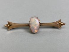 Unmarked antique gold bar brooch set with a pear shaped opal approximately 5 x 10mm, total weight