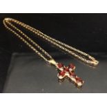 9ct Gold chain with a 9ct Gold pendant cross set with garnets (total weight approx 6.5g