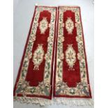 Chinese wool rugs, two sculpted hall runners with typical designs of flowers against red back ground