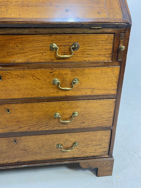 Oak Bureau with four drawers, fall front revealing pigeon holes and ornate key to lock approx 97 x - Image 11 of 14