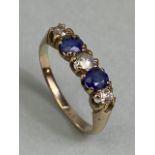 9ct yellow gold five stone ring set with two Sapphires and three diamonds in a liner setting