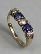 9ct yellow gold five stone ring set with two Sapphires and three diamonds in a liner setting