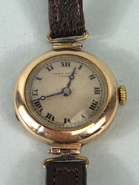 9ct Gold Ladies early 20th century round wrist watch on leather strap approximately 14.86g