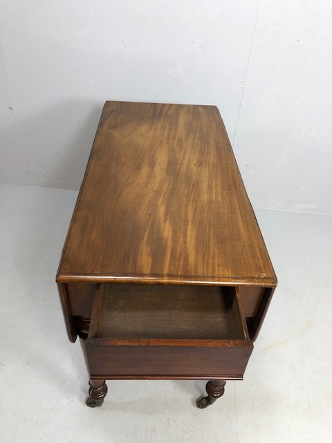 Pembroke table in flame mahogany on turned legs on casters, drawers to either end - Image 2 of 8