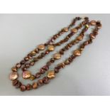 Pearls, a string of bronze dyed baroque pearls with 14kt clasp approximately 36in