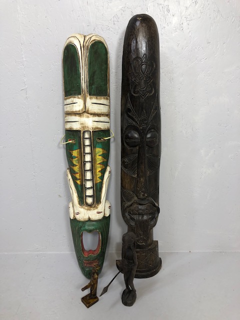 Decorative tribal interest, two large carved wall masks, African figure and an Egyptian fertility