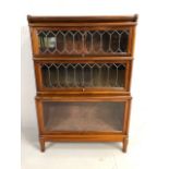 Three section Globe Wernicke bookcase with two leaded glazed panel doors, the lower stepped case