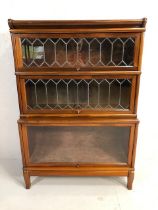 Three section Globe Wernicke bookcase with two leaded glazed panel doors, the lower stepped case