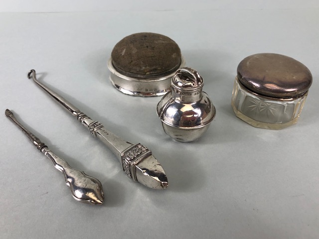 Silver Hallmarked pin box, silver top glass vanity pot, two button hooks and powder pot, five